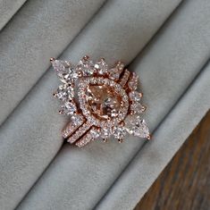 a diamond ring sitting on top of a white cloth