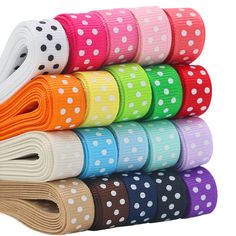 a stack of colorful polka dot ribbon on top of each other in different colors and sizes