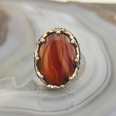 The ring is made of 925 sterling silver and adorned with Striped agate stone. PRODUCT FEATURES -Products are shipped with free shipping with box and bag. - Crafting Material : 925K Sterling Silver - Weight : 18.0 grams - Gemstone Diameter : 18 x 25 mm - Gemstone :Striped agate - Gender : Male / Female ✔ Ready to Ship in 1-3 Business Days ✔ Shipped to the worldwide 1-3 business days with free express shipping. ✔ The product will be sent to you with a box to avoid any damage during shipping. Diges Agate Gemstone Rings In Oval Cabochon Shape, Agate Gemstone Rings In Oval Cabochon, Oval Agate Rings With Polished Finish, Polished Agate Oval Cabochon Rings, Oval Cabochon Agate Ring With Polished Finish, Oval Agate Signet Ring With Polished Finish, Oval Agate Hallmarked Rings, Oval Brown Agate Rings, Brown Oval Agate Rings