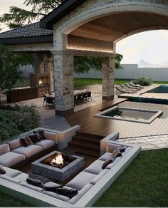 an outdoor living area with couches and fire pit