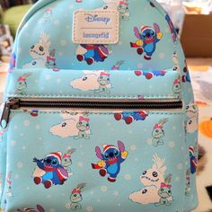 Loungefly Disney Stitch Christmas Backpack. Super Cute Christmas Design Has A Large Zipper Compartment And A Small Zipper Pocket On The Front. There Are Adjustable Straps And A Leather Loop On Top. Cute Blue Bag For Disney Fan Events, Blue Disney Bags For Gifts, Disney Style Backpack Bag For Gifts, Disney Style Backpack Bag As Gift, Loungefly Disney Backpack, Disney Stitch Christmas, Disney Backpack, Mickey Mouse Backpack, Minnie Mouse Backpack