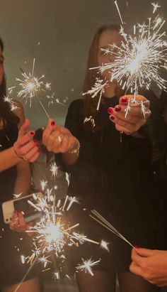 two women holding sparklers in their hands