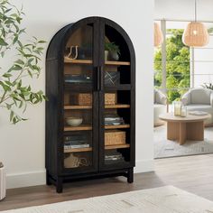 an arched bookcase with wicker baskets on the front and bottom shelves, in a living room