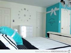 a bedroom with blue and white walls, black and white bedding, and a chandelier hanging from the ceiling