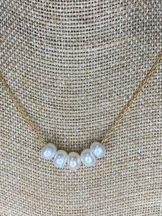 "This is a dainty but strong 14 K GF chain that holds 5 white freshwater pearls in a rondelle shape.  The pearls are free to move on the chain.  Treat yourself to this sweet and trendy necklace - you won't regret it.  It would also be a great gift for someone special in your life.   Item Features: - Handmade necklace - 18\" long  - Single strand - 14 K GF chain with 5 white freshwater pearls - Spring Ring closure Processing Time: These items are ready to be shipped out. You can expect just 1-2 d 14k Gold-filled White Pearl Chain Jewelry, 14k Gold-filled Pearl White Jewelry With Pearl Chain, Elegant Gold-tone Pearl Necklace With Adjustable Chain, White 14k Gold-filled Pearl Pendant Necklace, Elegant 14k Gold-filled Pearl Chain Charm Necklace, Trendy Necklaces, White Freshwater Pearl, June Birth Stone, Spring Rings