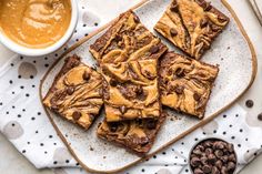 peanut butter brownies on a plate next to a bowl of chocolate chips