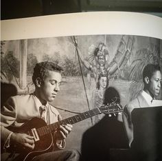 an old photo of a man playing guitar