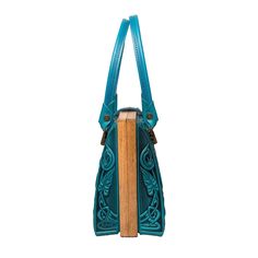 Introducing our Turquoise Teal Blue Purse, a stylish top handle bag that makes an ideal gift for her. Dimensions: 10.8 x 7.6 x 4.5 inches (27.5 x 19.5 x 11.5 cm) Material: Crafted from a combination of genuine leather and real oak wood. Please Note: The actual color of the item may vary slightly from the pictures shown on the website due to differences in monitor brightness settings on your computer. Blue Double Handle Box Bag For Formal Occasions, Blue Top Handle Box Bag For Everyday Use, Blue Shoulder Box Bag As Gift, Blue Satchel Shoulder Bag As Gift, Turquoise Top Handle Shoulder Bag For Travel, Blue Box Shoulder Bag As Gift, Handheld Blue Satchel As Gift, Blue Handheld Satchel As A Gift, Blue Shoulder Bag Satchel For Gift