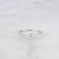 Delicate opal ring, that is perfect for stacking or wearing alone. A true beauty and must have! Made of 925 Sterling Silver We use a THICK DURABLE 14k Gold, Rose Gold or Rhodium plating - for a piece that will last you years to come! Lab Created Opal Stones - made of the highest quality for an authentic look! Available in sizes 4-10 Nickel-Free & Hypoallergenic Ring Measurements: Flower: 7.5mm Band Width: 1mm Dainty Opal Ring, Layering Diamond Necklaces, Gold Opal Ring, Opal Stacking Ring, Sterling Silver Opal Ring, Silver Opal Ring, Ring Opal, Opal Ring Gold, Opal Engagement