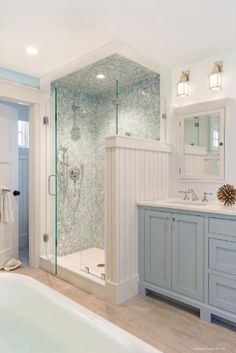 a bathroom with a tub, sink and shower in it's own area is shown