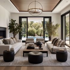 a living room filled with lots of furniture and a fire place in front of a window