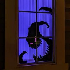 an image of a window with a cat looking out at the night sky through it