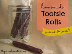 a jar filled with toothbrushes next to a sign that says homemade tootsie rolls