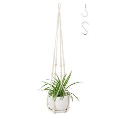 a white hanging planter with beads and a succulent