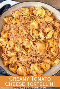 creamy tomato cheese tortellini in a skillet on a wooden table with text overlay