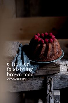 a chocolate cake with raspberries on top and the words g tips for food styling brown