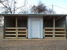 a metal building with wooden slats on the sides and a white door at the top