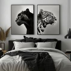 two black and white paintings on the wall above a bed