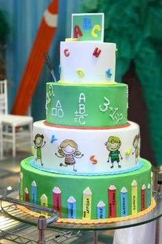 a multi layer cake with children's drawings on it