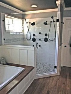 a bathroom with a walk in shower next to a bath tub