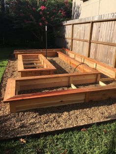 a wooden garden bed sitting on top of a lush green field