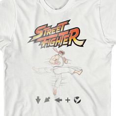 Celebrate your favorite video games in style with this Street Fighter Classic tee. The shirt features a faded image of Ryu above a sequence of buttons while orange and yellow letters above the image spell out the game's logo. The tee comes in a white short sleeve crew neck. Street Fighter fans will love this comfy cotton tee. White Gamer T-shirt With Graphic Print, White Gamer Graphic Print T-shirt, Gamer Style Screen Print T-shirt For Streetwear, Gamer Style Graphic Print Short Sleeve Shirt, Gamer Style White Top For Streetwear, White Gamer Tops With Graphic Print, White Cotton Gamer T-shirt, Boys White T Shirt, Yellow Letters