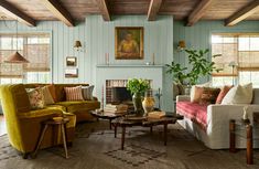 a living room filled with furniture and a fire place in the middle of a room