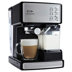 a coffee maker with a cup of coffee on the side and milk in front of it