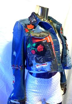 a mannequin wearing a jean jacket with patches on it