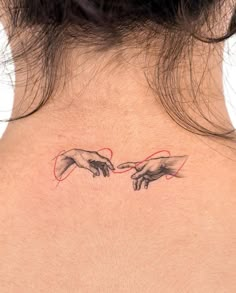 a woman's back neck with two hands touching each other and the outline of the creation behind it