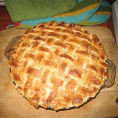 a pie sitting on top of a wooden cutting board