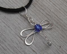 "This sweet little sterling silver dragonfly pendant is accented with a 4mm blue faceted glass bead. All the wire is sterling silver She measures about 7/8- 1\" (2.3 -2.6 cm ) from the top of her head to the bottom of the tail. The sterling silver bail adds about 1/2\" (1.3cm) making it about 1 1/4 - 1 1/2\" (3.2- 3.9cm) from the top of the bail to the bottom of the dragonfly. The widest part across is about 3/4-1\" (1.9- 2.6cm). You can add a 30\" black satin cord with NO clasp that can be tied Silver Wire Jewelry, Dragonfly Jewelry, Wire Jewelry Designs, Dragonfly Necklace, Dragonfly Pendant, Wire Pendant, Birthstone Gifts, September Birthstone, Jewelry Women