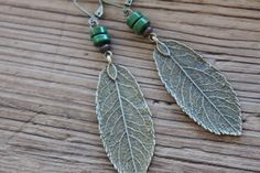 Boho Earrings, Dangle Leaf Earrings, Bohemian Earrings, Boho Jewelry, Green Brass Earrings, Nature Lover Gift Earrings Boho earrings made with turquoise green rondelle stones and brass leaves charms. They're hang from lever-back antique brass tone ear wires ( lead and nickel free).  For more choices on my brass boho earrings, please refer to the link below: https://www.etsy.com/shop/NtikArtJewelry?ref=seller-platform-mcnav&section_id=16059931 Color : Green stones beads Finish of the main pieces : Antiqued Brass Leaf ( 48x19mm)  Size : 2 3/4 inches including the antiqued brass lever backs Ear wire : Antiqued Brass lever backs Available with in turquoise patina : https://www.etsy.com/listing/203814583/turquoise-boho-earrings-dangle-drop Thanks for stopping by and for supporting my small busi Green Bohemian Earrings For Everyday Wear, Green Bohemian Earrings For Everyday, Earthy Green Drop Earrings, Rustic Green Earrings For Gifting, Rustic Green Earrings For Gift, Handmade Rustic Green Earrings, Rustic Handmade Green Earrings, Green Rustic Dangle Earrings, Rustic Green Dangle Earrings