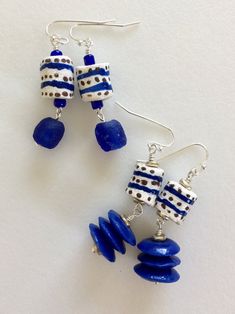 "Gorgeous African Krobo beads from Ghana in royal blue and white. Pretty 13 x 11 mm recycled powdered glass tube beads hand painted with blue stripes and tiny brown dots on bright white. Highly glazed 15 mm saucer discs in royal blue. And large transparent 10 mm blue glass rounds combined with antique silver heishi beads on Sterling silver plated French ear hooks. Two different styles, both approximately 2\" long with lots of movement. Listing is for one pair of earrings. Please select either 1) Krobo Beads, Recycled Glass Bead, Silver Earrings Handmade, Garnet Jewelry, Earrings Inspiration, African Beads, Heishi Beads, Trade Beads, Earrings Blue