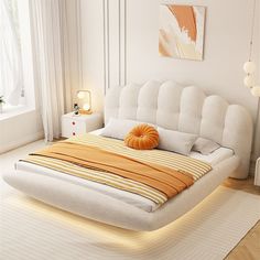 a white bed sitting in a bedroom on top of a hard wood floor next to a window