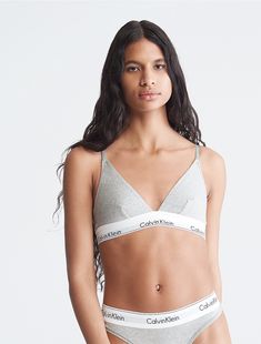 A Calvin Klein icon. This modern cotton bralette is the definition of effortless. Made with super soft and supple cotton stretch blended with modal for all day comfort. Designed with the original Calvin Klein logo band, this is a sporty look that feels sexy everyday.  Material: 53% Cotton, 35% Modal, 12% Elastane. Tight Tank Top, Calvin Klein Bralette, Calvin Klein Bra, Bra Image, Cotton Bralette, Triangle Bralette, Black Bralette, Calvin Klein Woman, Sporty Look