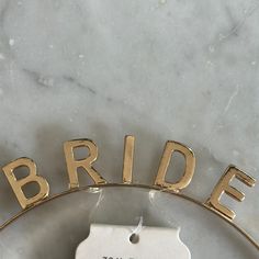 a bride or groom gift tag on a marble surface with the word bride hanging from it