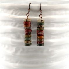 Red Jasper multiple heishi shaped beads on ceramic bowl Multicolor Earthy Dangle Earrings, Earthy Multicolor Dangle Earrings, Earthy Multicolor Earrings For Gift, Earthy Multicolor Earrings Perfect For Gifts, Dangle Jasper Earrings With Ear Wire, Earthy Elegance, Red Creek Jasper, Picasso Jasper, Fall Earrings