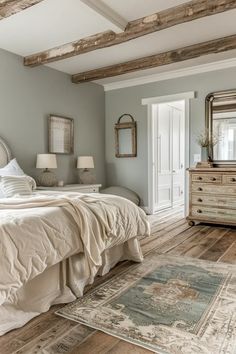 a large bed sitting in a bedroom next to a dresser and mirror on top of a wooden floor