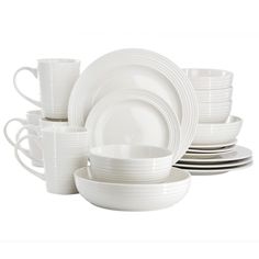 white dishes and cups are stacked on top of each other