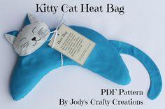 a blue kitty cat pillow with a tag attached to it's back and the words kitty cat heat bag written on it