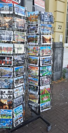 there are many newspaper racks on the sidewalk