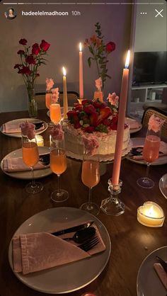 an image of a table setting with candles and flowers on it for a celebration or special occasion