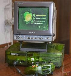 an old video game system sitting on top of a wooden table