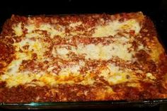 a square pizza sitting on top of a pan covered in cheese and meat sauces