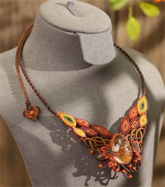 a necklace with an orange and yellow design on it