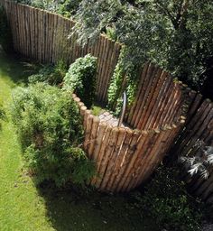 a wooden fence in the middle of a yard