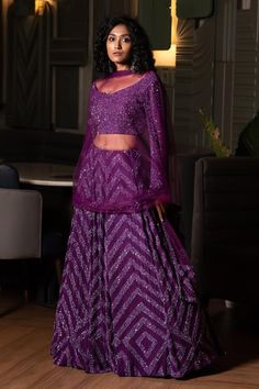 Purple can can attached lehenga skirt with sequin embellished chevron patterns. Comes with matching padded blouse and dupatta.
Components: 3
Pattern: Embroidered
Type Of Work: Cutdana,Sequin
Neckline: V-neck
Sleeve Type: Full
Fabric: Lehenga and Blouse: Georgette, Dupatta: Tulle, Lining: Shantoon, Dupion Silk
Color: Purple
Other Details: 
Attached lining
Length:
Lehenga: 44 inches
Blouse: 15 inches
Closure: Blouse: Back hook
Note: Kindly contact customer service for sleeve customization at an ex Traditional Drape Palazzo Set With Sequins For Diwali, Sequin Lehenga For Eid Reception, Eid Reception Lehenga With Sequins, Traditional Sequin Palazzo Set For Reception, Traditional Palazzo Set With Sequins For Reception, Bollywood Style Purple Palazzo Set With Mirror Work, Wedding Navratri Purple Palazzo Set, Purple Cutdana Lehenga For Reception, Purple Sequin Dresses With Traditional Drape