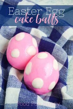 two pink cake balls sitting on top of a blue and white checkered cloth