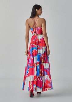 The hannah dress is an ikat-inspired flared maxi dress featuring a tiered effect. It showcases a hand micro-pleated bodice and stylish side cutouts, blending traditional craftsmanship with contemporary design for a uniquely elegant look. Bohemian Tiered Skirt Maxi Dress For Party, Chic Multicolor Maxi Dress, Chic Multicolor Tiered Maxi Dress, Bohemian Tiered Maxi Dress For Party, Fitted Tiered Maxi Dress For Beach, Spring Maxi Dress With Ikat Print, Chic Multicolor Flowy Maxi Dress, Fitted Multicolor Tiered Maxi Dress, Elegant Tiered Multicolor Maxi Dress